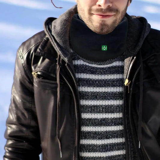 Person wearing a black leather jacket, striped sweater, and dark hoodie with a blue sky background using heating scarf