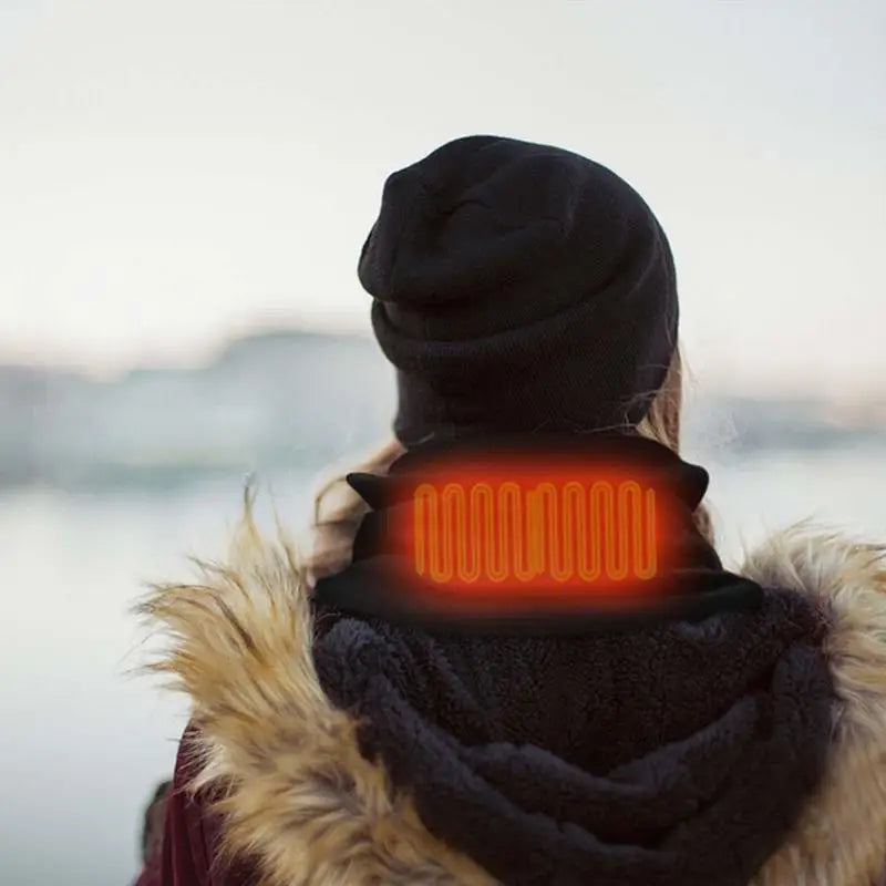 Person wearing a heated neck scarf with a scenic background